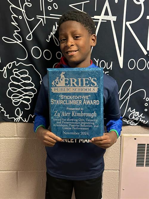 Zy'Aier Kimbrough, McKinley's November Stairclimber, poses with his plaque.